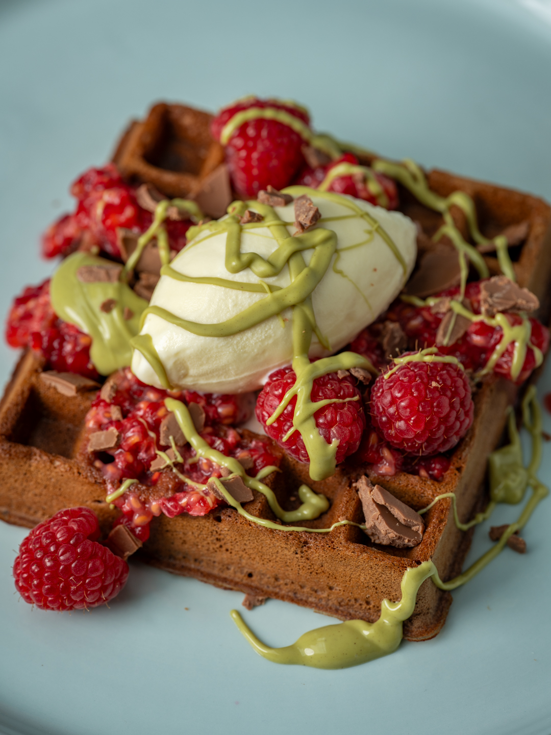 Crushed Chocolate Easter Egg Waffles with Raspberries and Pistachio 