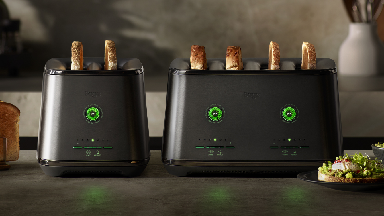 Two Sage Eye Q toasters with toasted bread, displayed on a kitchen counter.