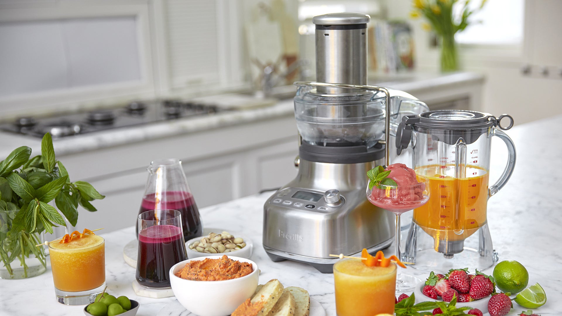 Appliance shown with prepared juices, smoothies, and ingredients.
