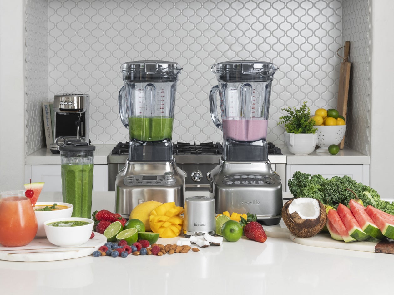 Blenders shown with smoothies, fresh fruit, and ingredients.