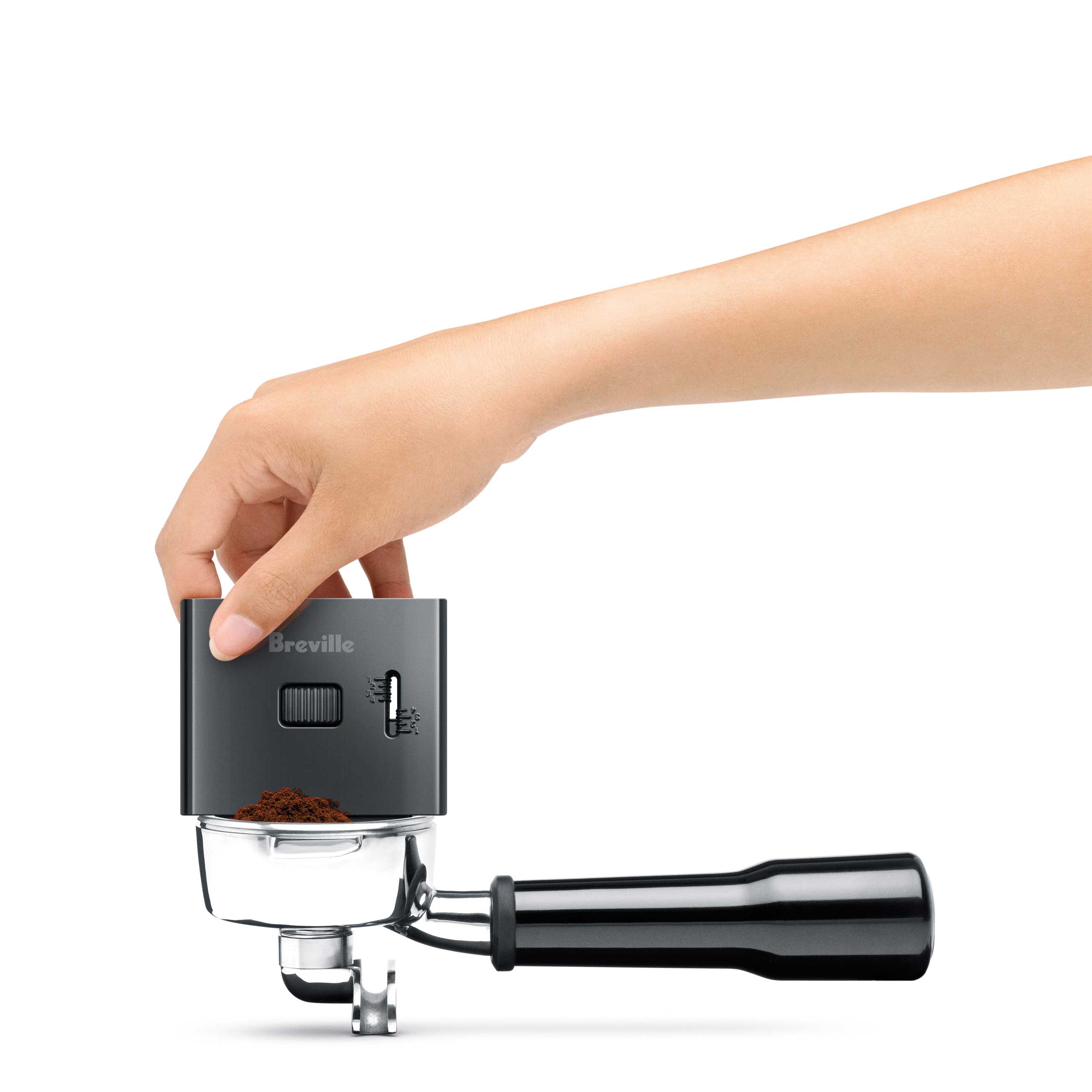 Using the adjustable razor to level the ground coffee precisely.