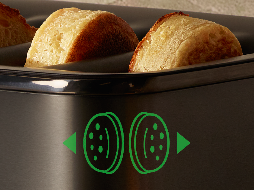 Close-up of bagels toasting in the Breville EyeQ toaster, with a  green icon indicating a bagel setting.