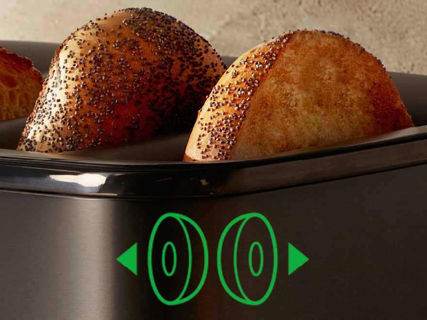 Close-up of bagels toasting in the Breville EyeQ toaster, with a  green icon indicating a bagel setting.