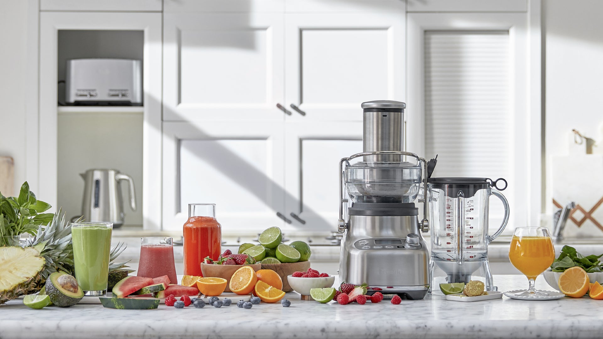 Appliance shown with juices, smoothies, and fresh fruit.