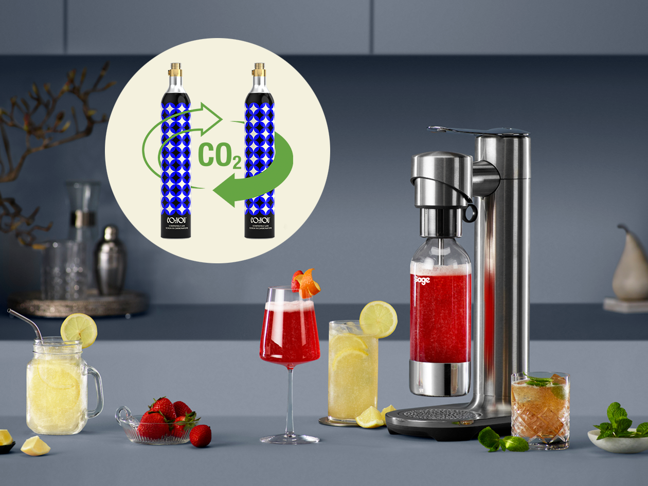 Infizz soda maker on a table next to cocktails