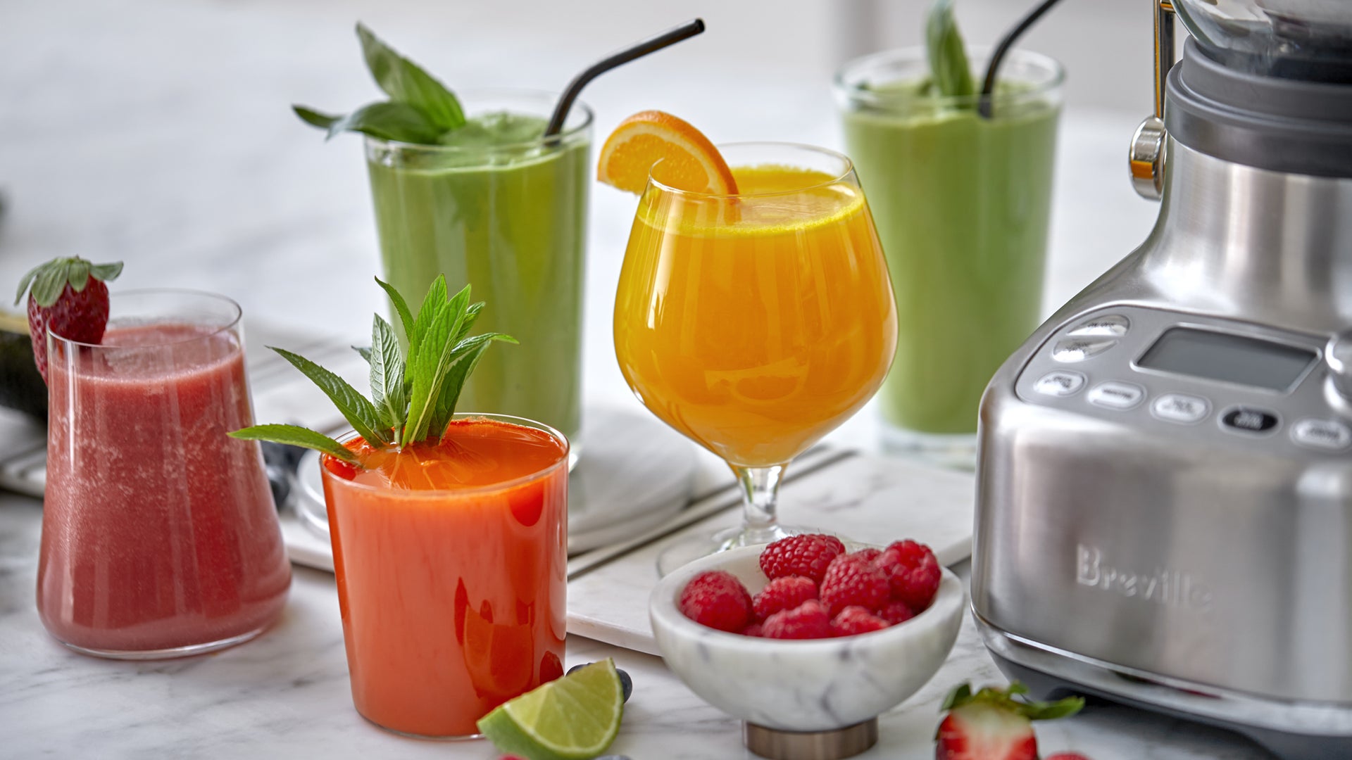 Assorted glasses of fresh juices and smoothies.
