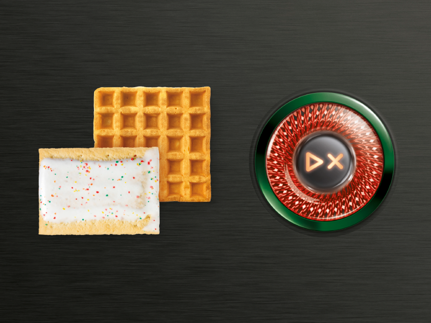 Waffle and frosted pastry beside the illuminated Breville EyeQ toaster control dial.