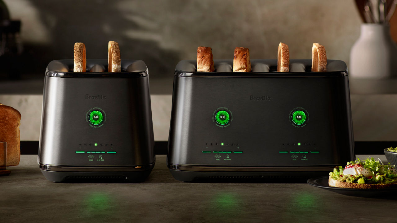 Two Breville EyeQ toasters with toasted bread, displayed on a kitchen counter.