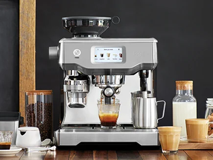 the Oracle™ Touch on bench with milk jug, latte glasses and various kitchen accessories